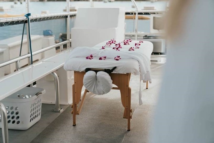 a bedroom with a bed and a chair in a room