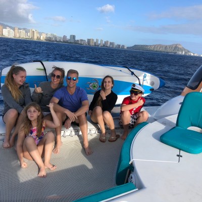 Andrea Barber et al. sitting next to a body of water