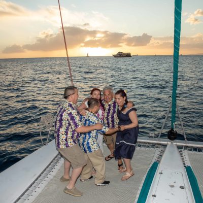 a man and a woman standing in front of a body of water