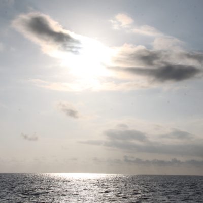 a group of clouds in the sky over a body of water