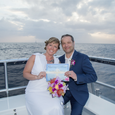 a woman standing in front of a body of water