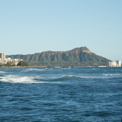 a large body of water with Diamond Head in the background