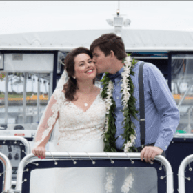 a man and a woman standing in front of a bus