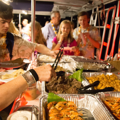 a group of people sitting at a table with food