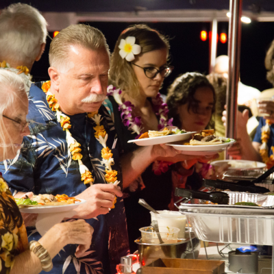 a group of people sitting at a table eating food