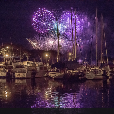 fireworks in the night sky over a body of water