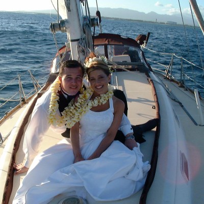 a person sitting on a dock next to a body of water