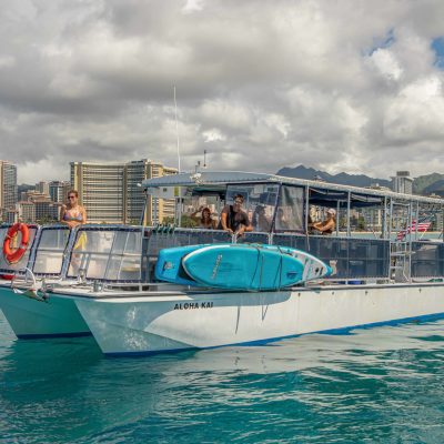 a blue and white boat sitting next to a body of water