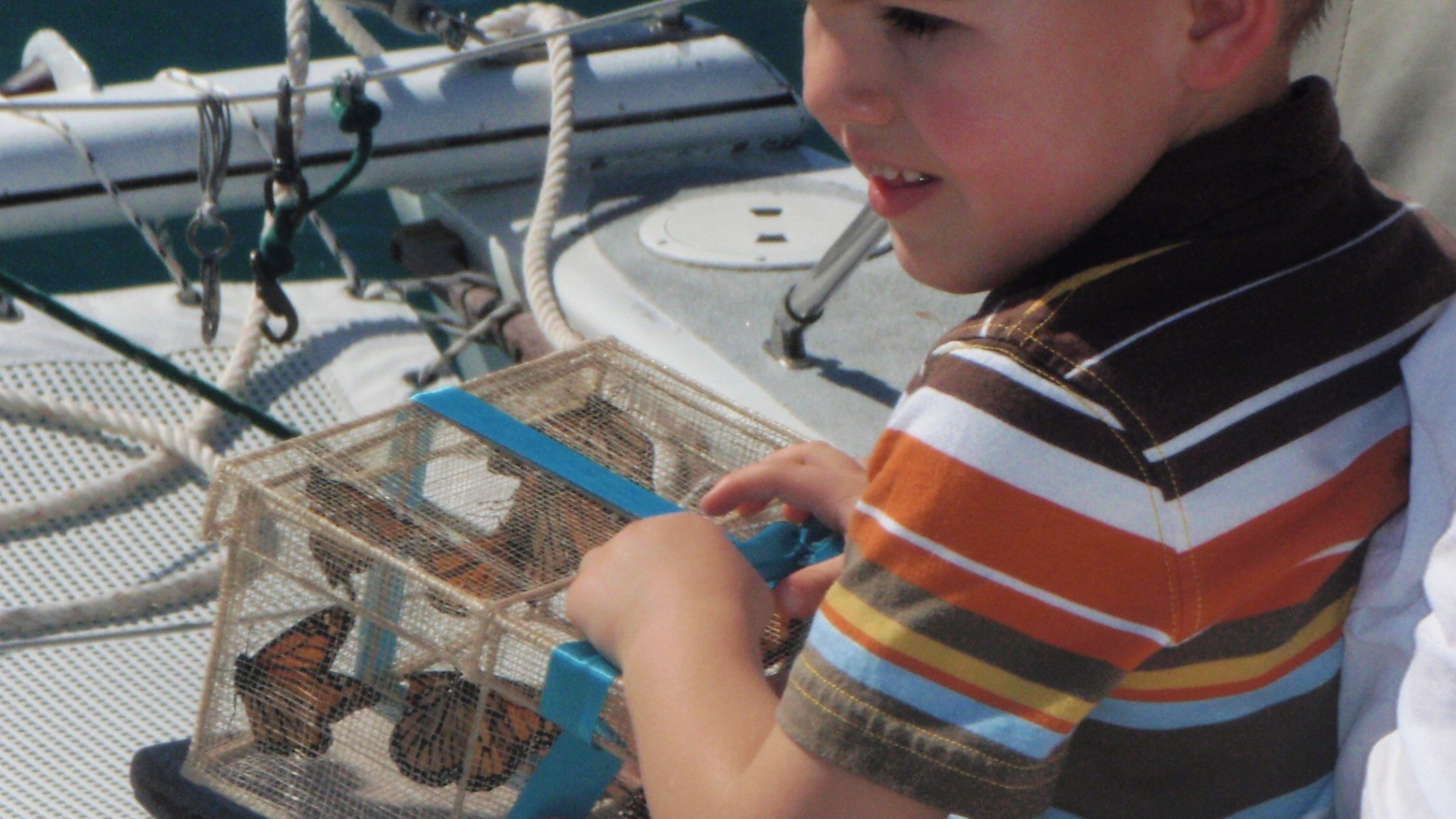 a little boy sitting on a boat