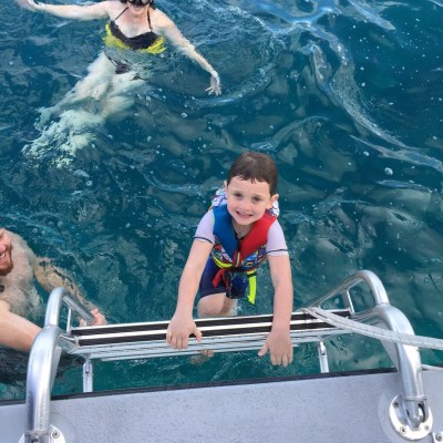 a man riding on the back of a pool of water