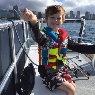 a little boy that is sitting on a boat