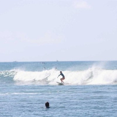 a man riding a wave on a surfboard in the water
