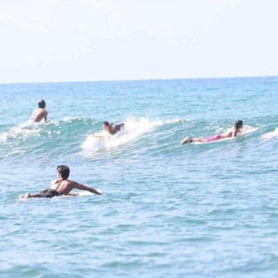 a man riding a wave on a surfboard in the water